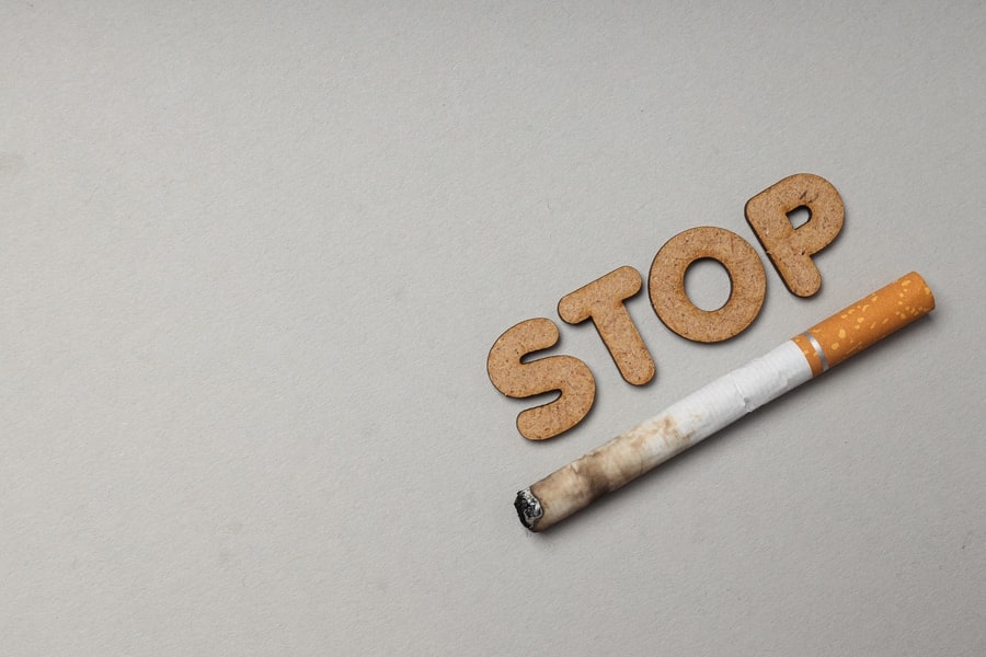 Smoking addiction concept, word: STOP, top view.